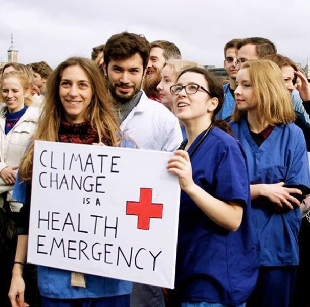 People marching with sign Climate Change is a Health Emergency