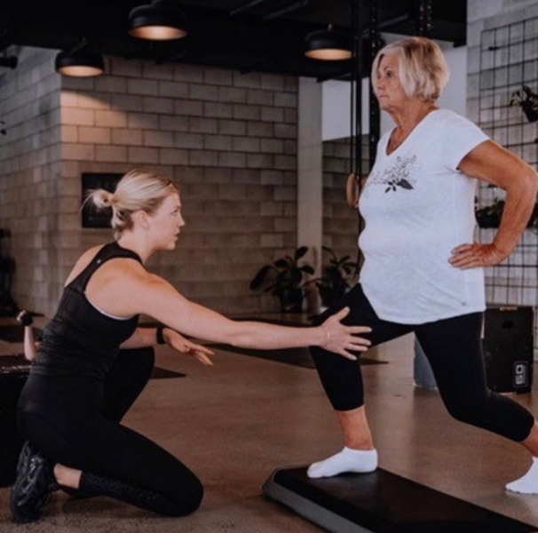 Older woman lunging whilst younger woman asists