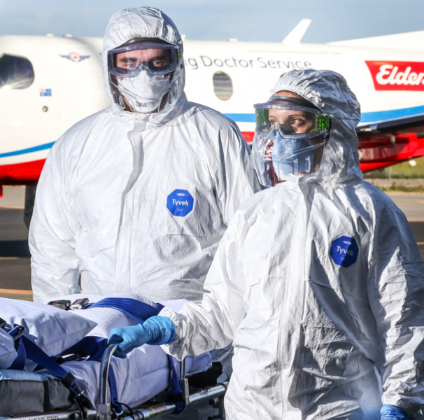RFDS crew with stretcher in from of RFDS aircraft