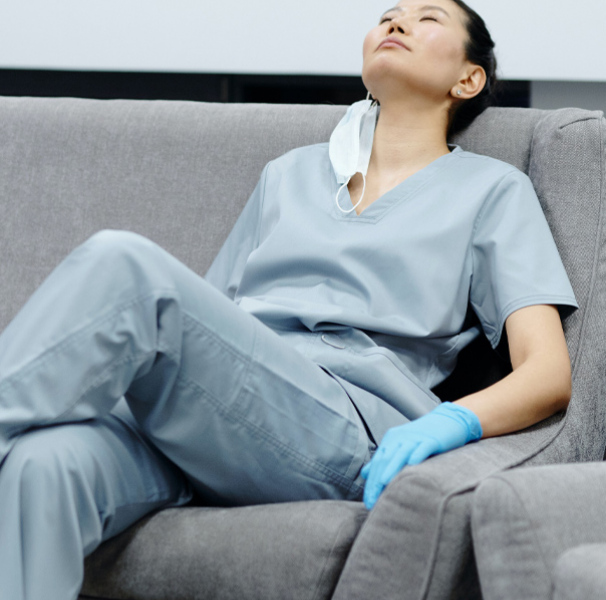 Woman resting on lounge wearing mask