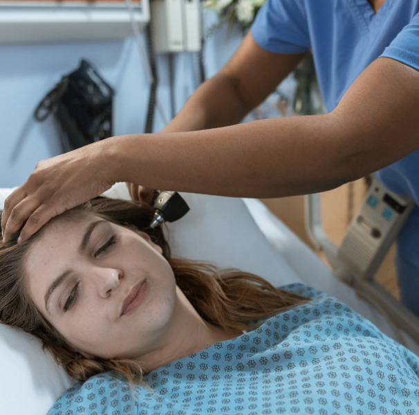 Nurse checking female patients temperature