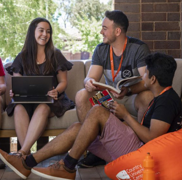 Students with laptops sitting together