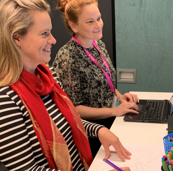 Two womel looking at computer