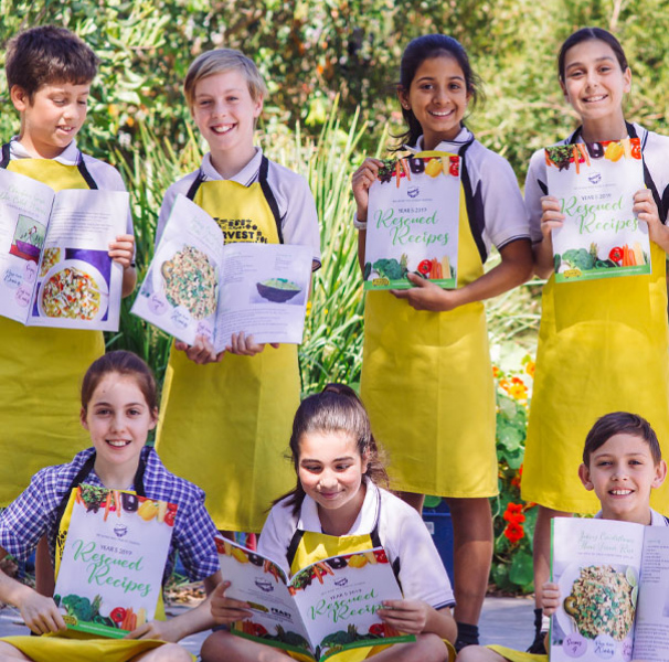 FEAST program kids holding recipe books