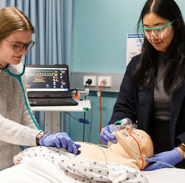 Two medical students with training dummy