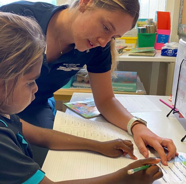 Yalgoo Primary School student Angelica Simms with occupational therapy student Keely Fitzpatrick.