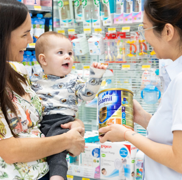 Pharmacists with mother and baby