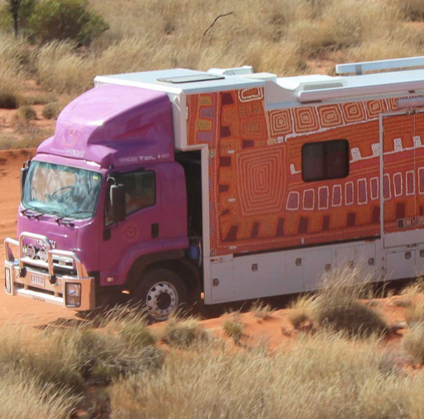 Purple truck on a red dirt track