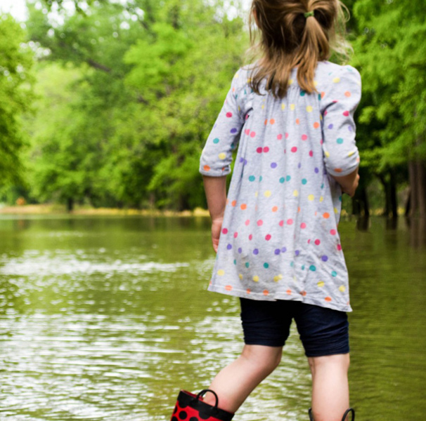 Young girl walking in flooded street