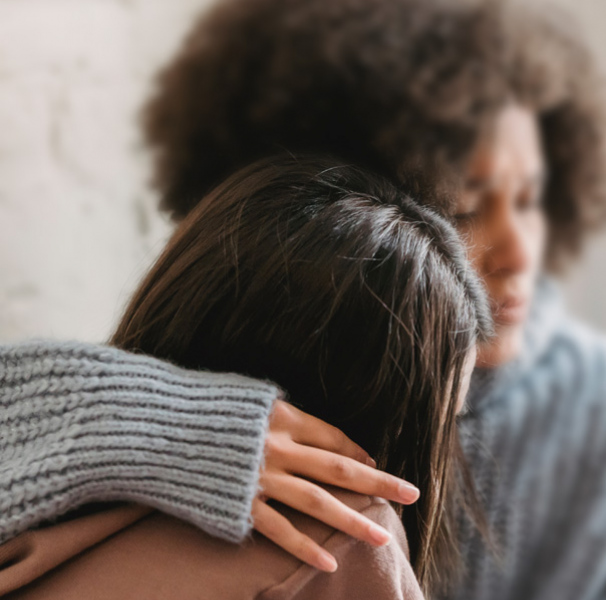 Woman hugging another woman