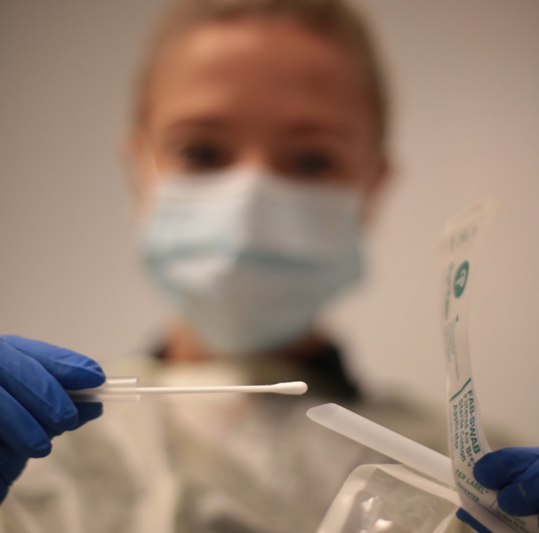 Medical person with cotton tip swab