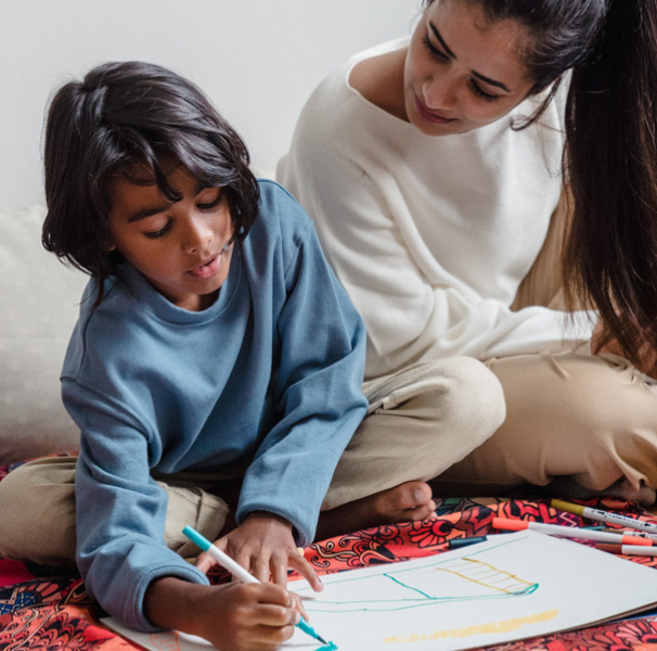 Mother helping son who is drawing