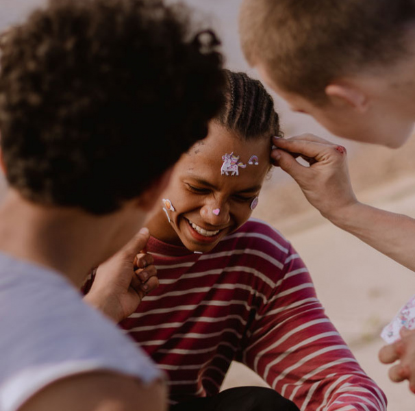Teenage boys having fun putting stickers on each other