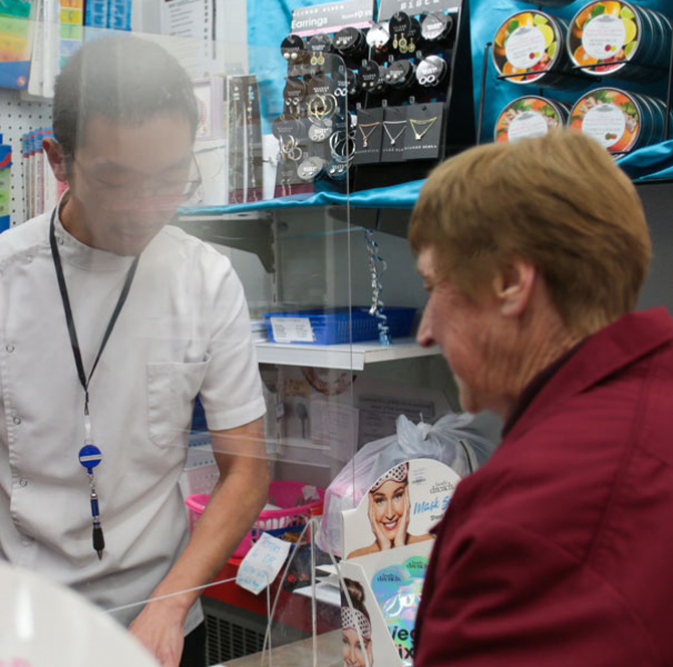 Pharmacist talking to customer