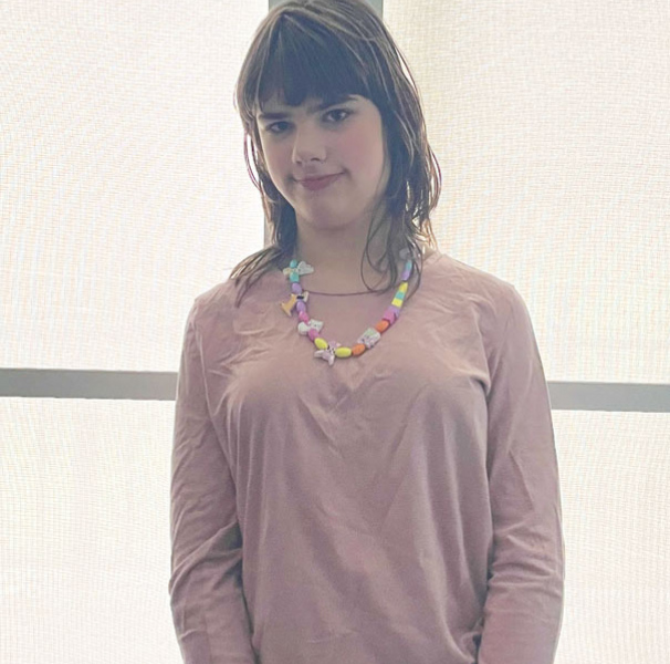Teenage girl in light pink top posing for camera