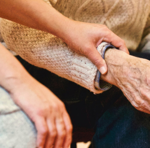 Woman holding mature mans hand