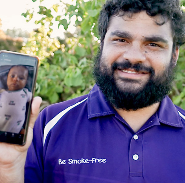 Man showing photo of his baby on mobile phone