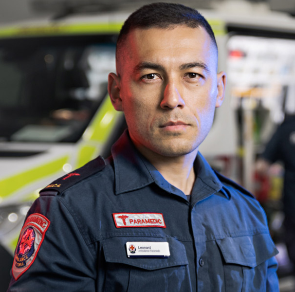 Male paramedic in front of ambulance