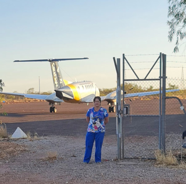 Woman with aeroplane in the background.