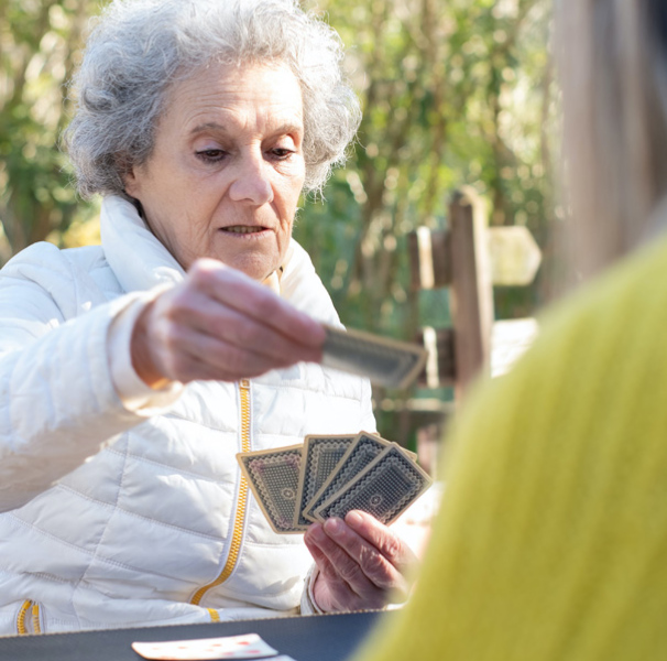 Elderly woman playing cards