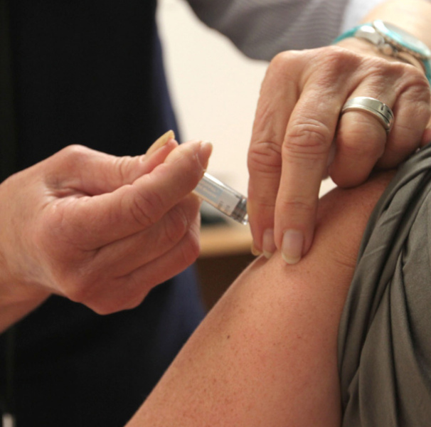Person receiving a vaccination injection