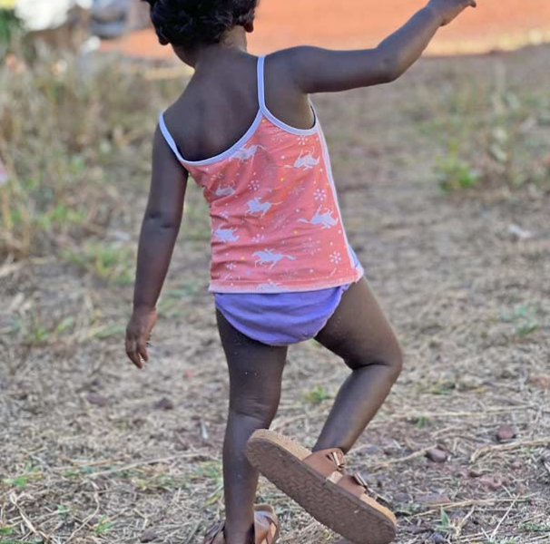 Young child wearing adult shoes
