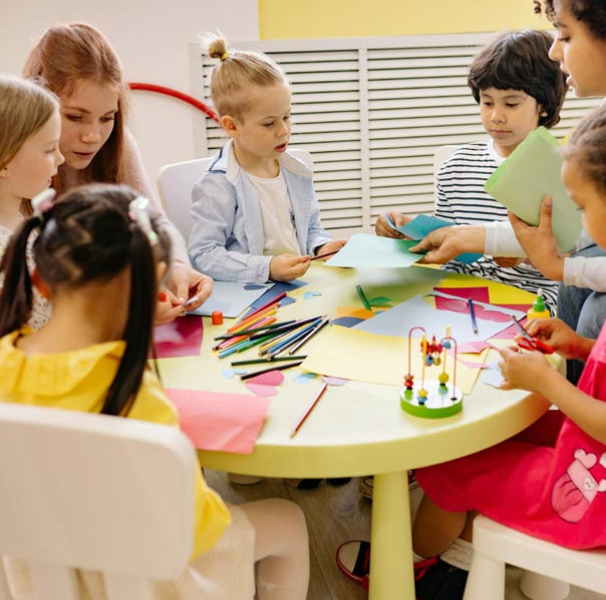Young children and teacher at a table