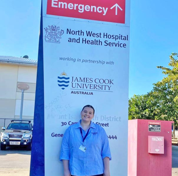Female medical student infront of Mt Isa Hospital sign