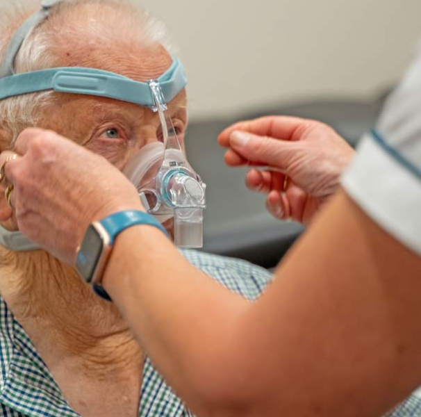 Pharmacist Karen fitting a sleep apnea mask.
