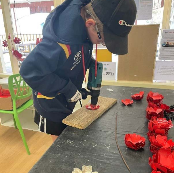 Preparing Metalwork Poppies for community soldiers memorial 