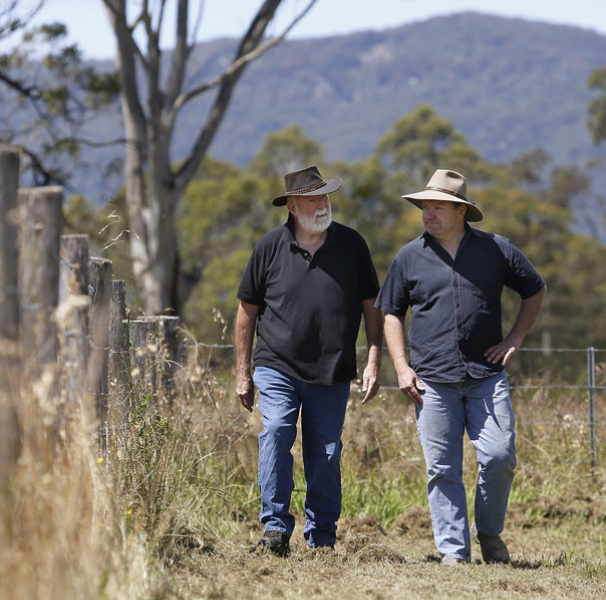 Two men walking on a rural property
