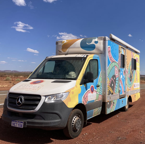 Earbus with illustration livery on a red earthy desert road