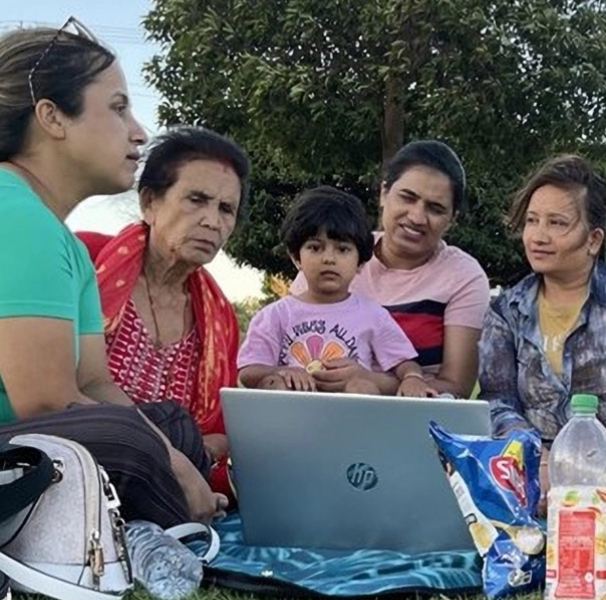 A bilingual health educator conducting a session outdoors.
