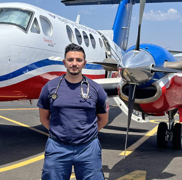 Dr Mina Arsanious in front of a RFDS aircraft